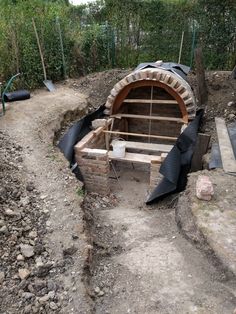 an outdoor oven is being built in the dirt