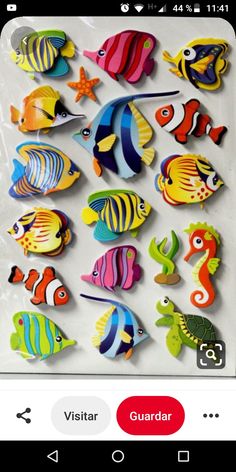 an assortment of colorful wooden fish on a white background