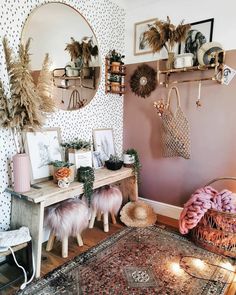 a room filled with lots of furniture and decor on top of a wooden floor next to a wall