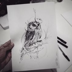 a drawing of an owl sitting on top of a piece of paper