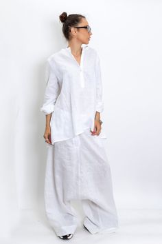 The White linen blouse women is our favorite weekender. Featuring an oversized relaxed fit with front button closing and long sleeves. The long sleeve shirt is made from lightweight linen, that is versatile for any occasion! The White linen blouse women is designed to be comfortable and not troublesome to wear. After wearing this White long sleeve linen shirt women, you will love it even more. ▸FABRIC The white linen blouse women is made from high quality 100% linen ▸SIZING This model linen shir Oversized White Solid Color Blouse, Baggy Lagenlook Tops, Baggy Long Sleeve Tops With Pockets, Solid Color Relaxed Fit Blouse For Daywear, Relaxed Fit Solid Color Blouse For Daywear, Spring Lagenlook Blouse Relaxed Fit, Oversized Long Sleeve Blouse With Pockets, Relaxed Long Sleeve Shirt For Loungewear, Oversized Long Sleeve Shirt For Loungewear