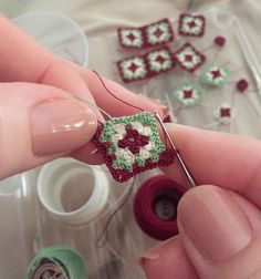 a person is holding some crocheted items in their hands and they are working on something