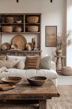 a living room filled with lots of furniture and baskets on top of the shelves in front of it