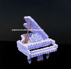 a paper sculpture of a piano on a table