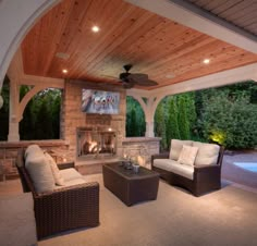 an outdoor living area with furniture and fireplace