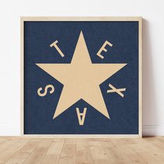 a wooden frame with a star and letters on the front in blue, beige and white