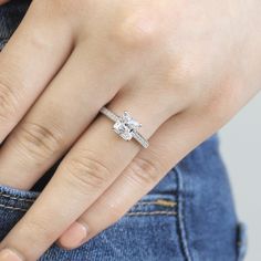 a woman's hand with a diamond ring on it