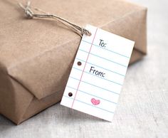 a gift wrapped in brown paper with a note attached to it