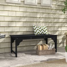 a black bench sitting in front of a house