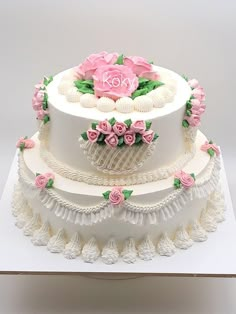 a three tiered cake with pink flowers on top