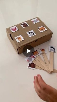 a box with stickers on it and someone's hand reaching out to grab one