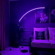 a living room filled with furniture and purple lighting