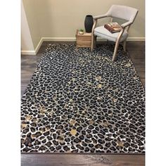 a leopard print area rug with a chair in the corner and a vase on the floor