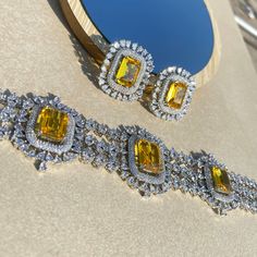 Fancy Yellow Sapphire Canary Diamond Choker Necklace is a masterpiece inspired by the timeless elegance of Harry Winston Jewellery. Adorned with resplendent Fancy Yellow Diamonds, a gracefully designed Yellow Sapphire Necklace, and a Yellow Choker embellished with the brilliance of American Diamonds, it encapsulates the opulence of Indian jewelry craftsmanship in every intricate detail. This exquisite piece is meticulously crafted, making it the perfect complement to enhance the allure of your Bridal Wedding ensemble. *𝐏𝐑𝐎𝐃𝐔𝐂𝐓 𝐃𝐄𝐓𝐀𝐈𝐋* * Material: Brass * Plating: White Rhodium Plated * Stone: AAA-quality CZ yellow diamond & canary diamond. *𝐃𝐈𝐌𝐄𝐍𝐒𝐈𝐎𝐍𝐒*  Necklace * Weight: 61 gm * Design Length: 8  inches * Total Length with Closure: 15.75 inches * Width: 1.7 Inches Harry Winston Jewelry, Yellow Diamond Necklace, Canary Diamond, Necklace Luxury, Diamond Choker Necklace, Fancy Yellow Diamond, Wedding Gifts For Bride, Diamond Choker, Cubic Zirconia Necklace