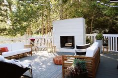 an outdoor living area with furniture and fire place