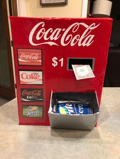 a coca - cola machine sitting on top of a counter