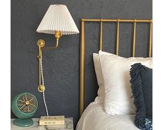 a lamp on a nightstand next to a bed