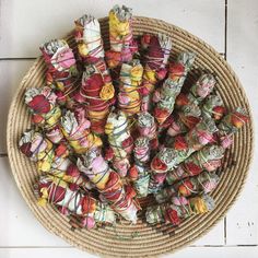 a basket filled with lots of candy wrapped in twine