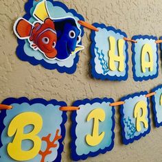 a happy birthday banner hanging on the wall