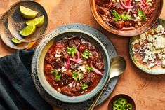 two bowls of chili with limes on the side