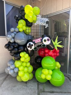 an assortment of balloons are displayed in front of a store