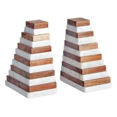 two white and brown wooden pyramids sitting next to each other on top of each other