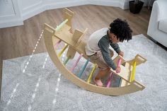 a child playing on a wooden toy boat