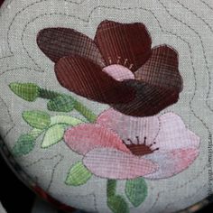 a close up of a flower on a cushion