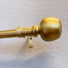 an image of a gold door handle on a white wall