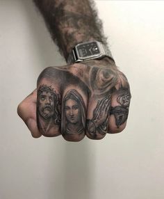 a man's hand with some tattoos on it