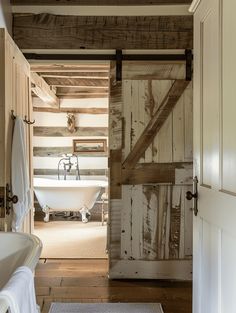 an open door leading to a bathroom with a bathtub