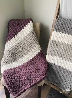 two blankets sitting next to each other on top of a wooden chair in a room