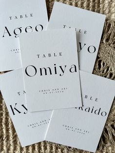 four pieces of white paper with black ink that say table o'niya on them