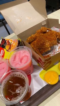 chicken wings, ice cream, and drinks are on a tray at a fast food restaurant