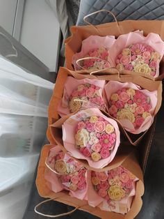 some pink and yellow flowers are wrapped in brown paper