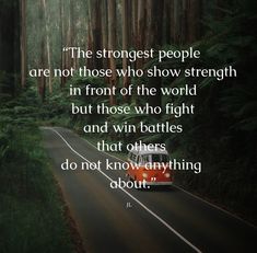 a red car driving down a road in the woods with a quote about people who are not those who show strength