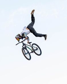 a man on a bike doing tricks in the air