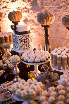 a table topped with lots of desserts and cupcakes on top of plates