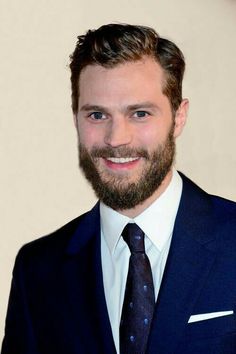 a man with a beard wearing a suit and tie