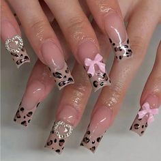 a woman's nails with pink bows and leopard print on them, while she is wearing