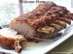 a plate with some meat on it and a fork next to it that says welcome home