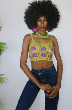 This crochet top is an ultra breezy and edgy style option. She is dyno-mite with a halter swim top or bralette. But for my free spirited sister, you can wear her as is to a festival or beach party. She's a retro green and with pink crochet flowers. She features a corset style back so that you can cater her to your own custom fit! Style Tip: Use as a swim stop cover or style with ribbed denim shorts for a easy casual look Made of Acrylic Scary Crochet, Crochet Outfits, Halter Swim Top, Pink Crochet, Sweater Crop, Halloween Aesthetic, Edgy Style, Crochet Bags, Free Spirited