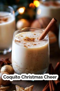 two glasses filled with coffee and cinnamon on top of a wooden table next to christmas decorations