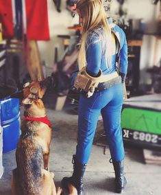 a woman standing next to a dog in a garage