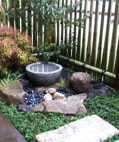 a small garden with rocks and plants in it