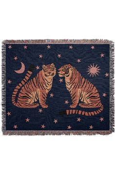 two tigers sitting next to each other on a blue background with stars and crescents