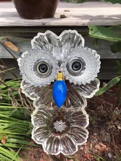 an owl glass figurine with a blue bead on it's eyes