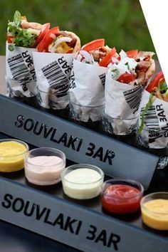 several different types of food on display with the words souvlak bar in front of them