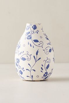 a blue and white vase sitting on top of a table