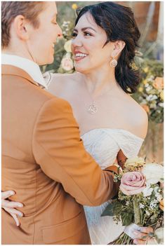 the bride and groom are smiling at each other